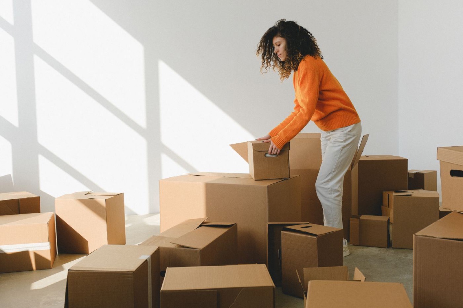 Moving boxes stacked in an empty, freshly cleaned apartment